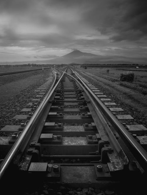 Grayscale Photo of Train Rail