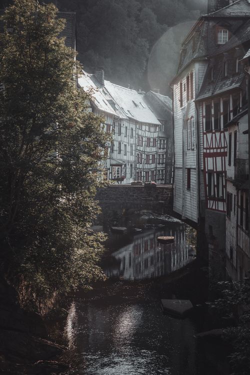 Free Peaceful view of Monschau with historic half-timbered buildings and scenic river reflecting serene atmosphere. Stock Photo
