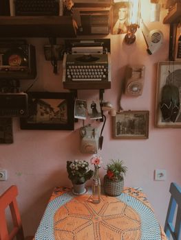 Charming interior featuring a typewriter, plants, and vintage decor in a cozy room.