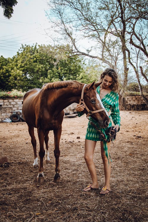 Woman in Green Dress Holding the Horse 