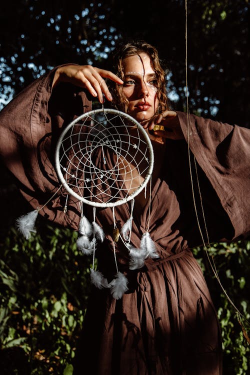A Woman Posing with a Dreamcatcher