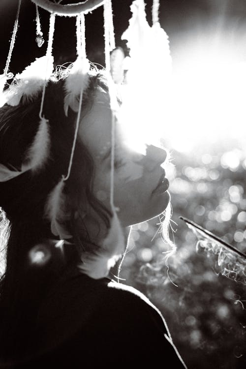 Grayscale Photo of Woman With Hanging Dreamcatcher 