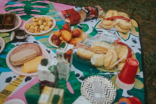 Free High angle view of a vibrant picnic spread with assorted foods, perfect for a sunny outdoor meal. Stock Photo