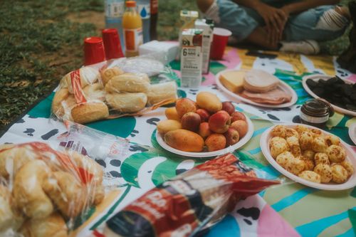 Free A vibrant picnic setup featuring various fruits, snacks, and drinks, perfect for outdoor gatherings. Stock Photo