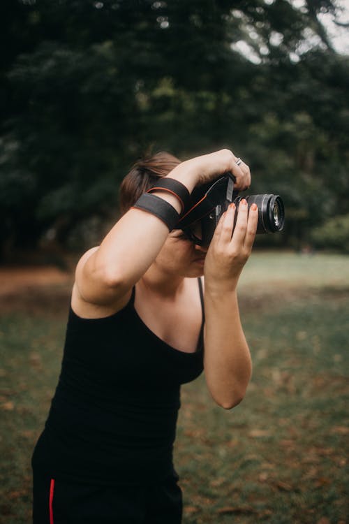 A Woman Using a DSLR Camera