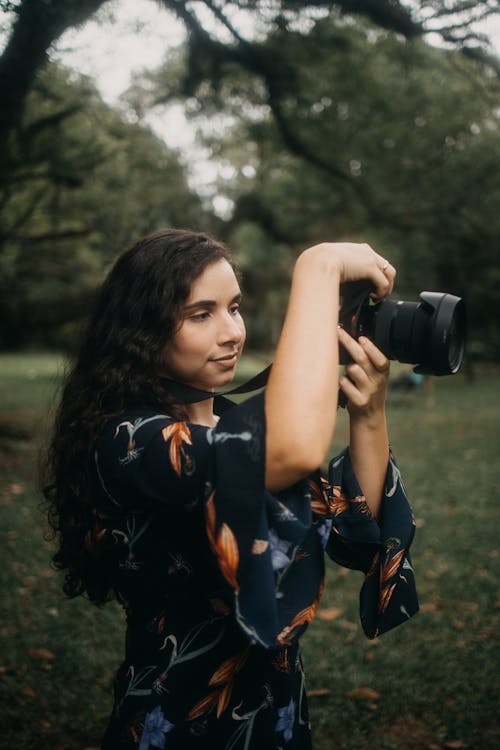 Free Woman Taking a Picture with an SLR Camera Stock Photo