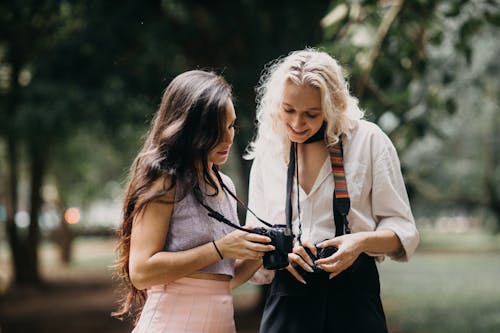Free Women Looking at Photos on Camera and Smiling  Stock Photo
