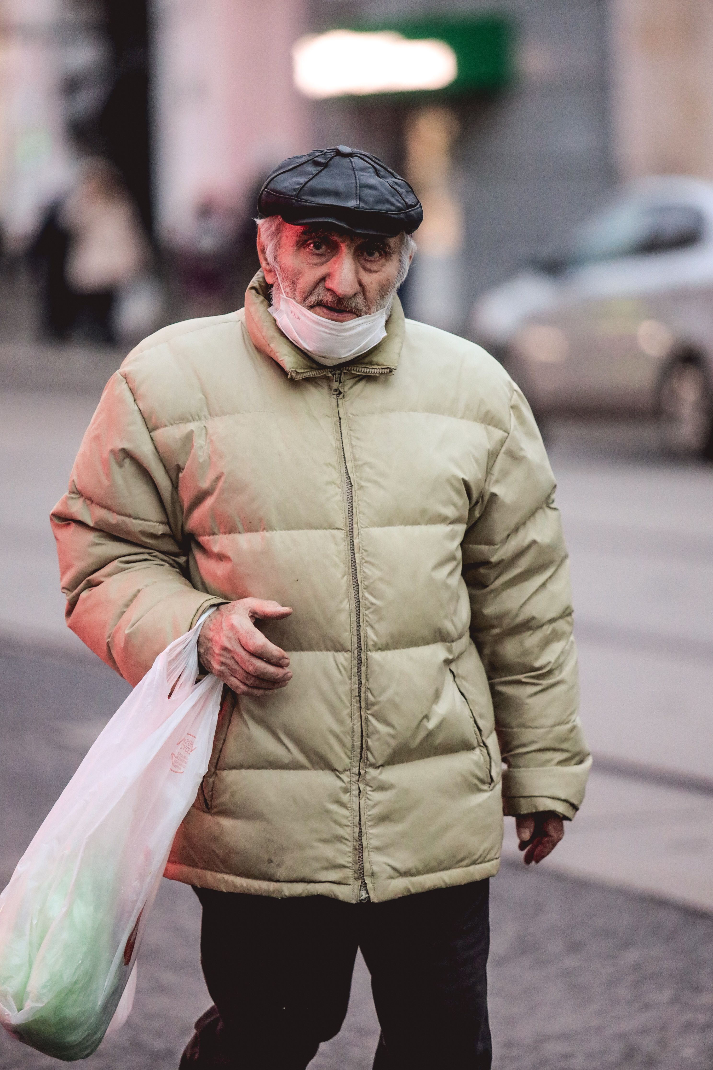 A Man in Brown Jacket and Black Cap Standing on Road · Free Stock Photo