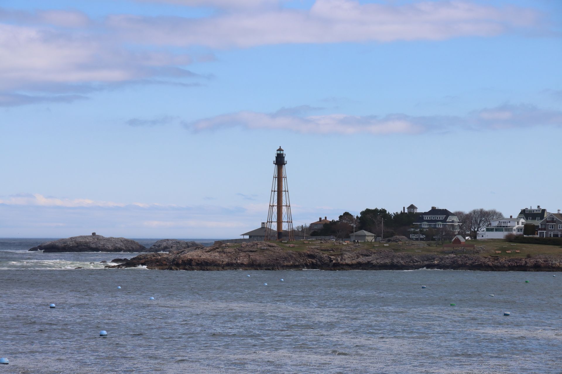 Photo of a Seacoast with a Tower against a Cloudy Sky