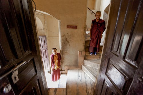 Buddhist Boys Standing on Steps Inside a Building