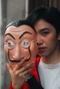 A Person Holding a Dali Mask Near Face