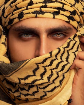 Close-up of a man's eyes with a patterned headscarf, showcasing cultural fashion.