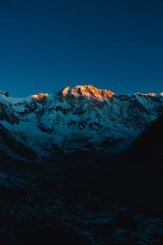 Stunning view of Annapurna mountain range with sunrise lighting the snow-capped peaks.