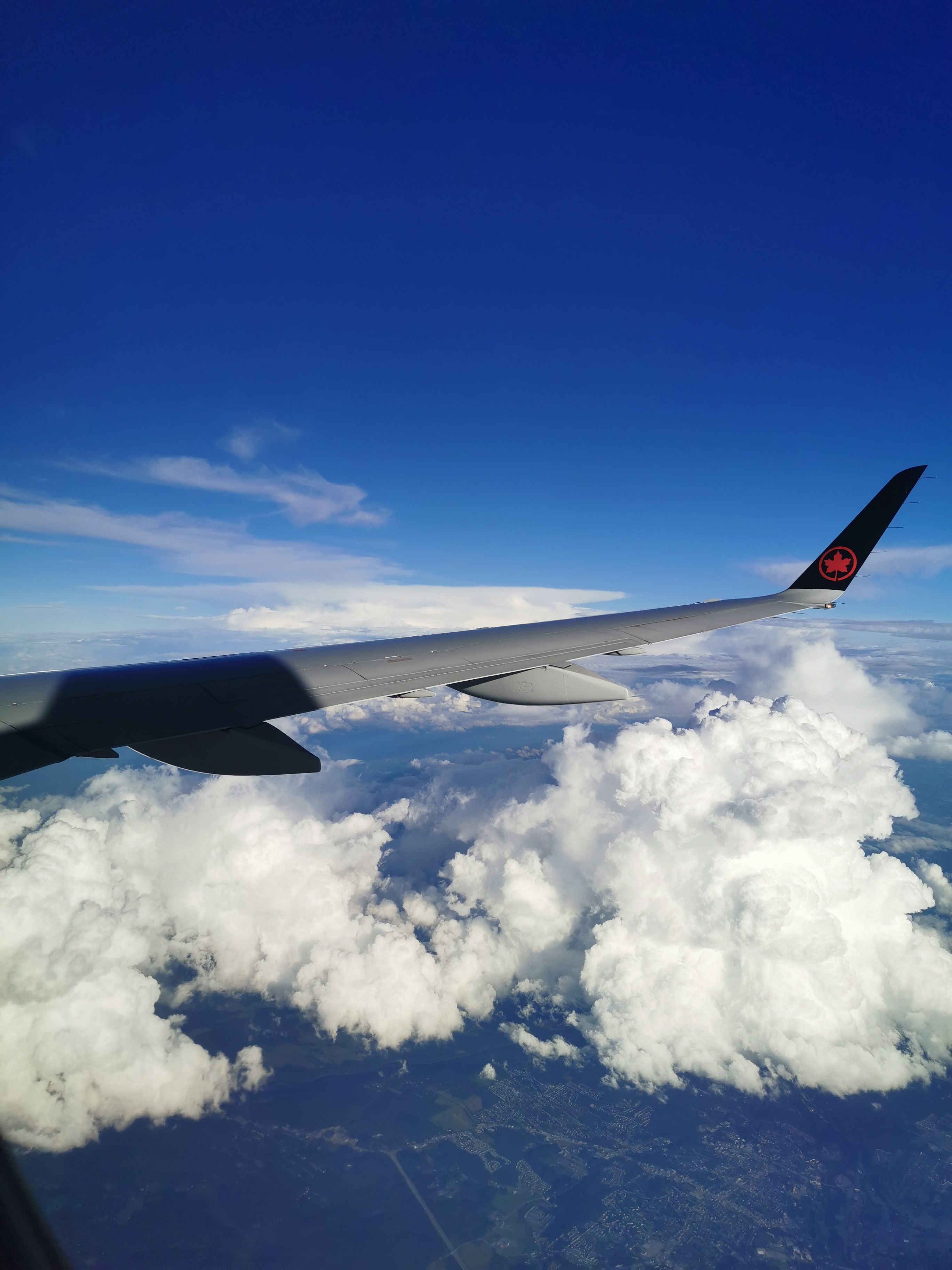 Breathtaking aerial view of clouds and blue sky from a commercial airplane.
