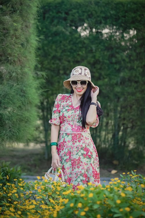 A Woman in Floral Dress and Bucket Hat