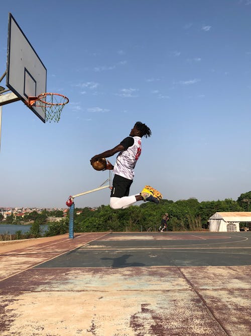 A Man Dunking a Basketball