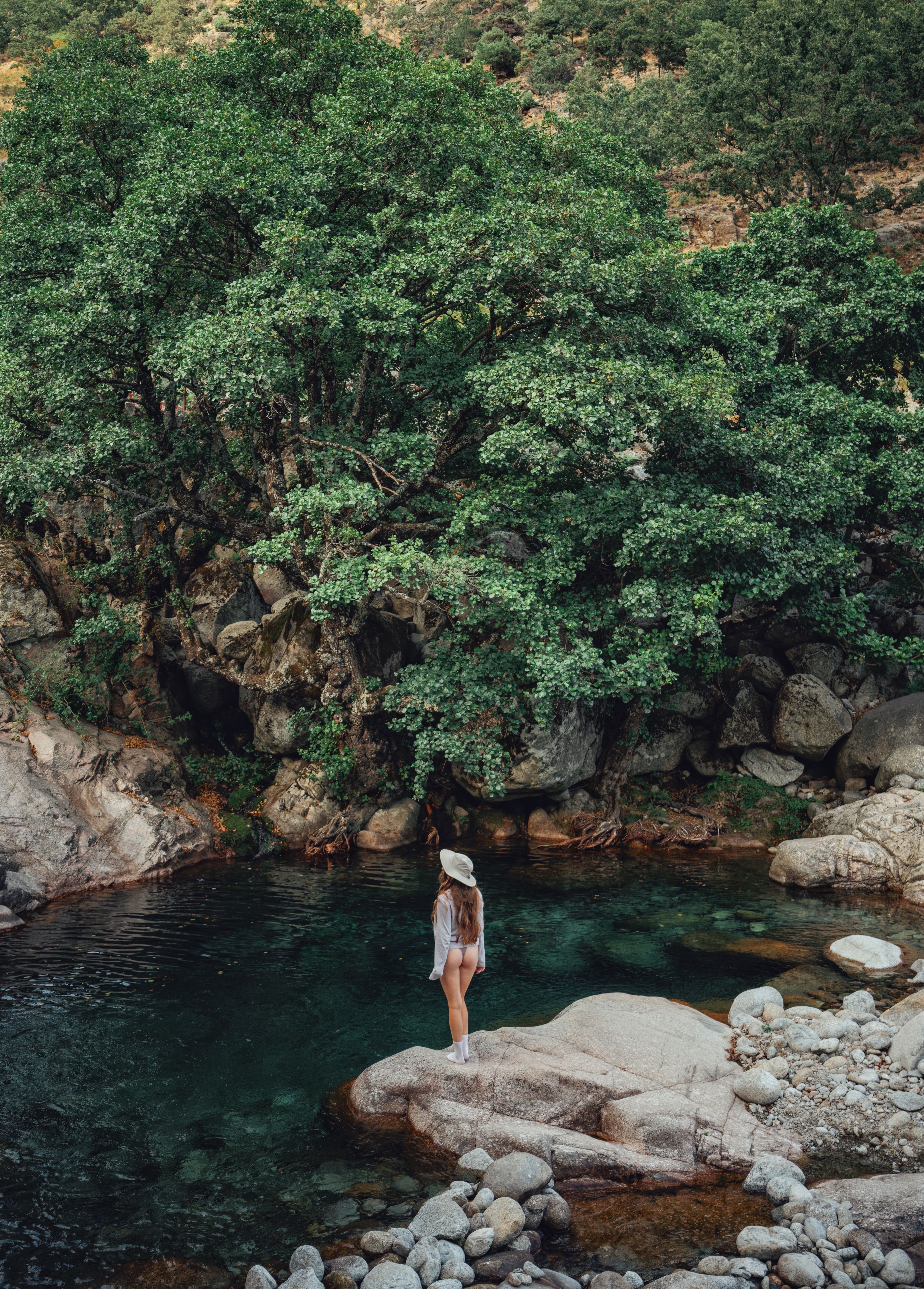 Woman Standing on a Rock on the Bank of a Mountain Lake · Free Stock Photo