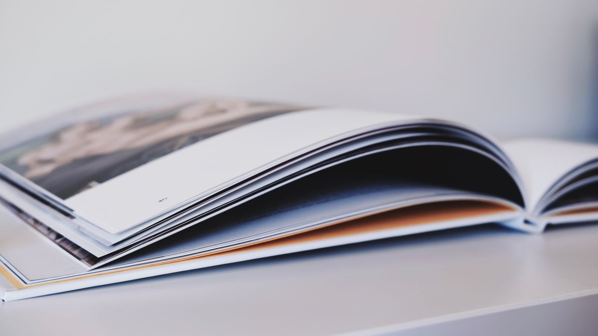 Open printed booklet on a table