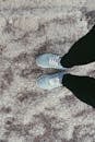 Person in Black Pants and Pair of Blue Sneakers