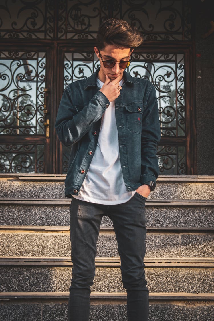 Man In Black Leather Jacket And Pants Standing Near Stairs