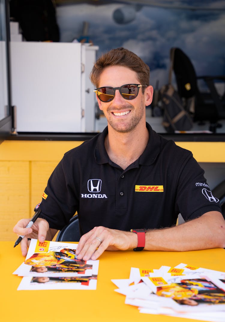 Man In Black Polo Shirt Wearing Sunglasses Smiling 