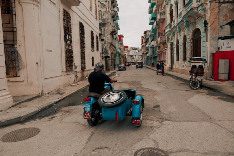 Man Riding A Tricycle 