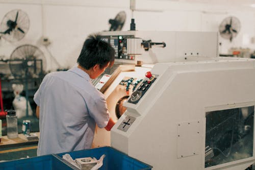 A Man Operating an Industrial Machinery