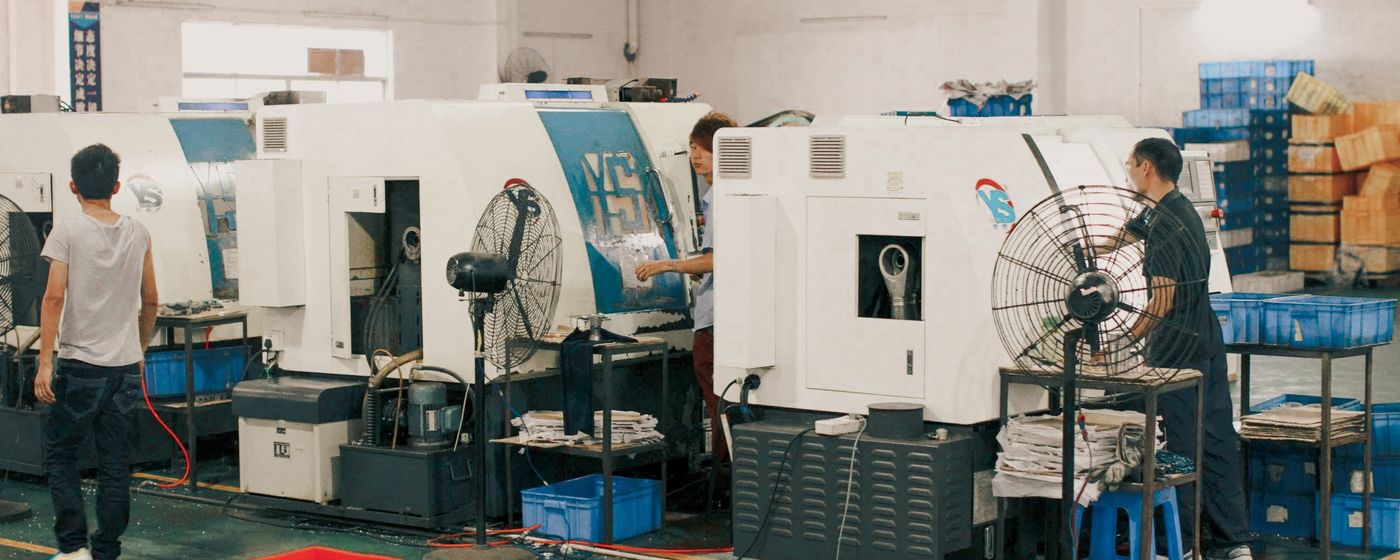 Workers operating machinery in factory