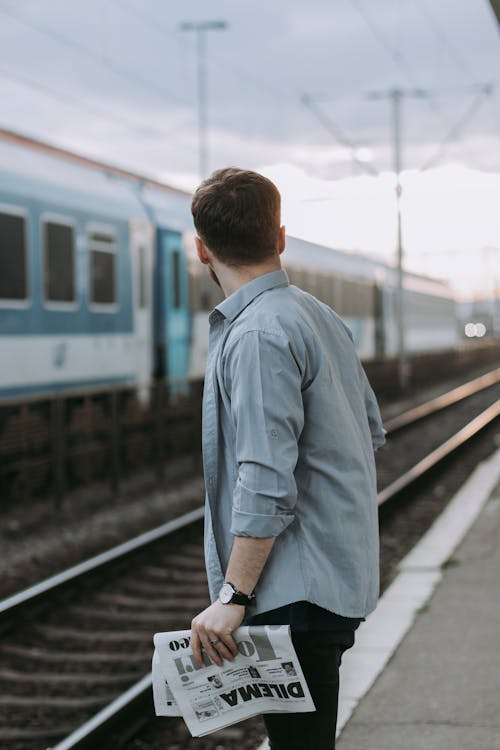 Free Man in Blue Dress Shirt Standing on Train Station Stock Photo