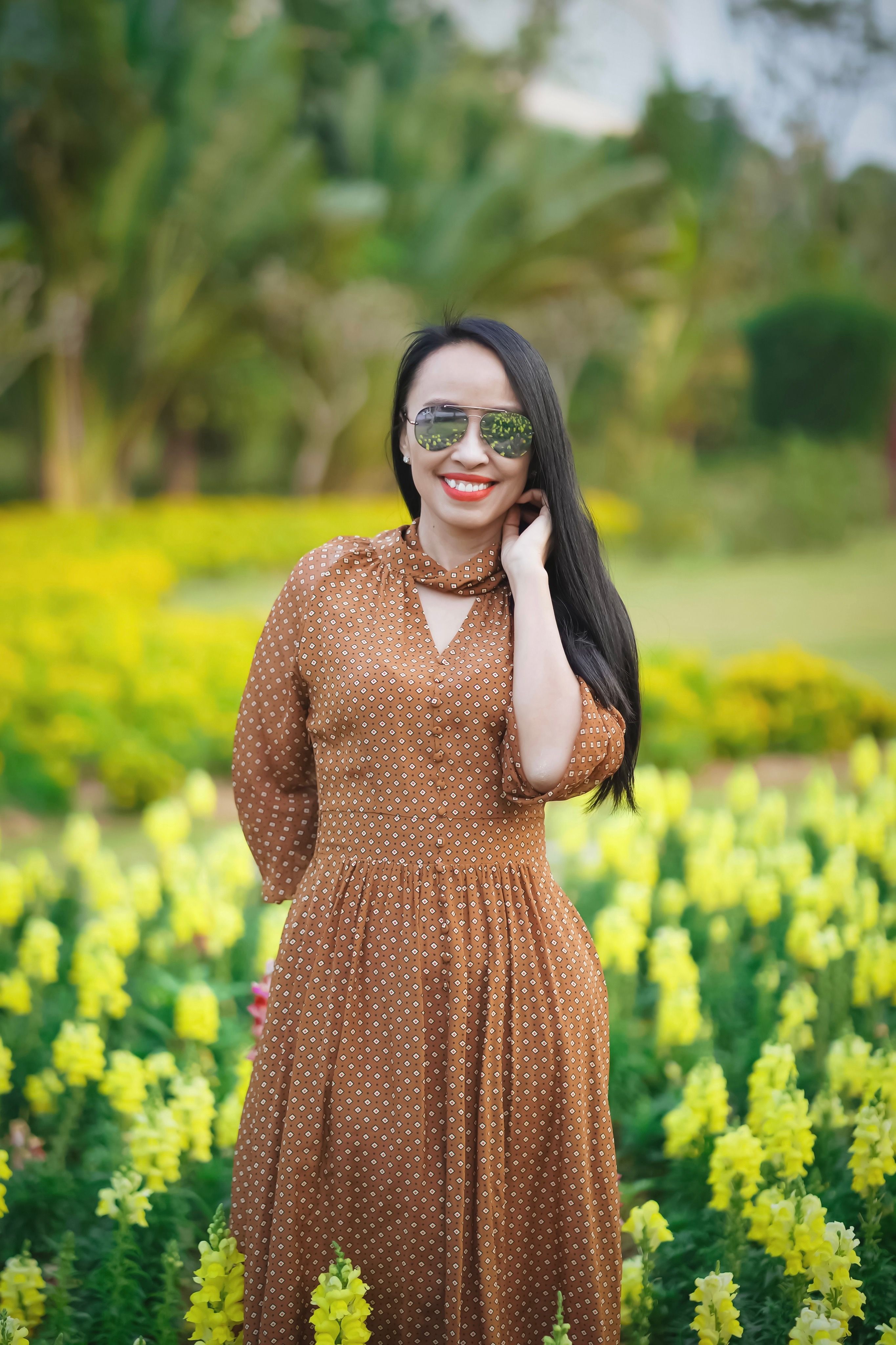 Woman in Brown Dress Standing on a Garden · Free Stock Photo