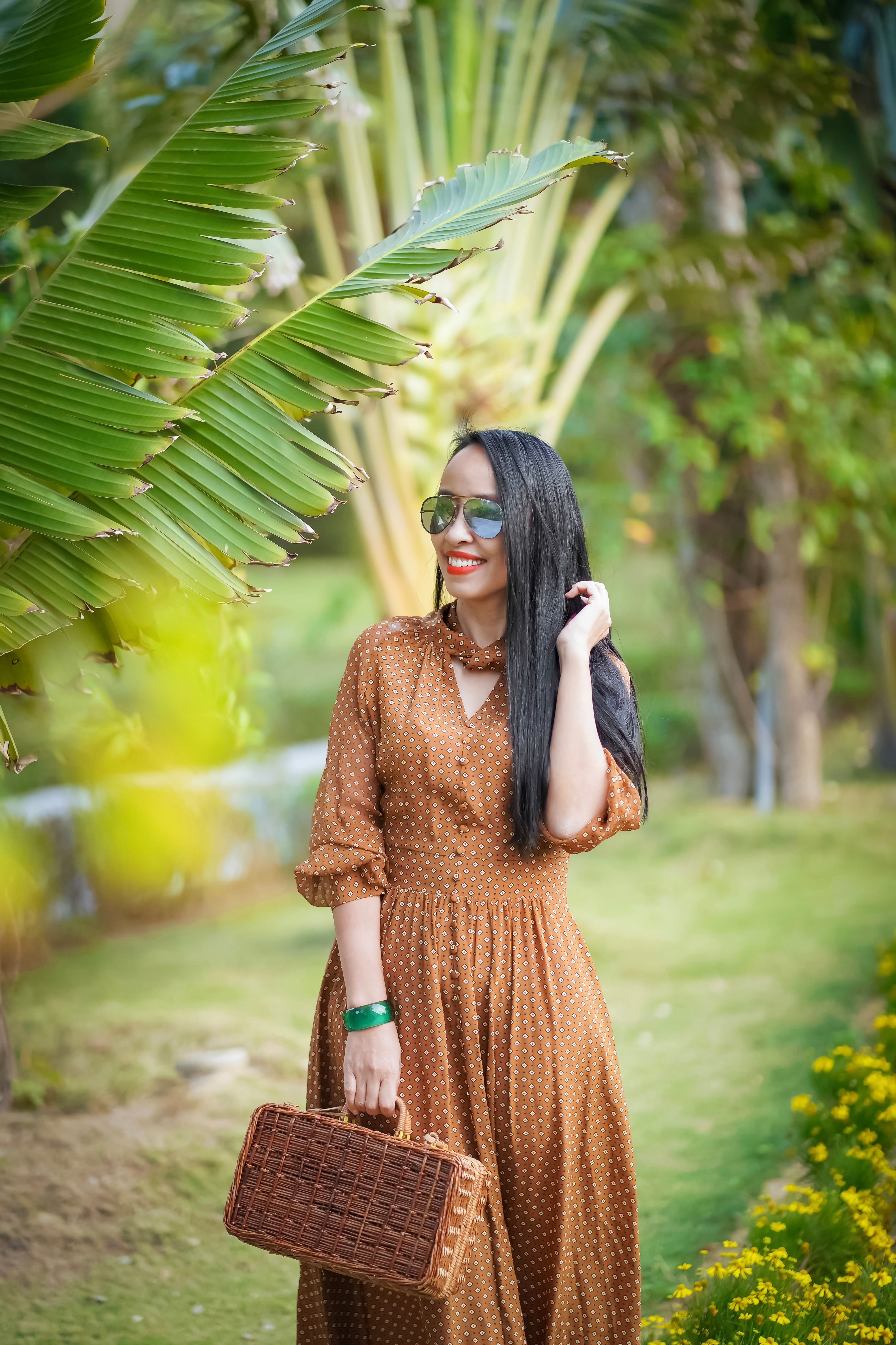 Woman in Brown Polka Dot Dress Standing Near Green Banana Tree · Free ...