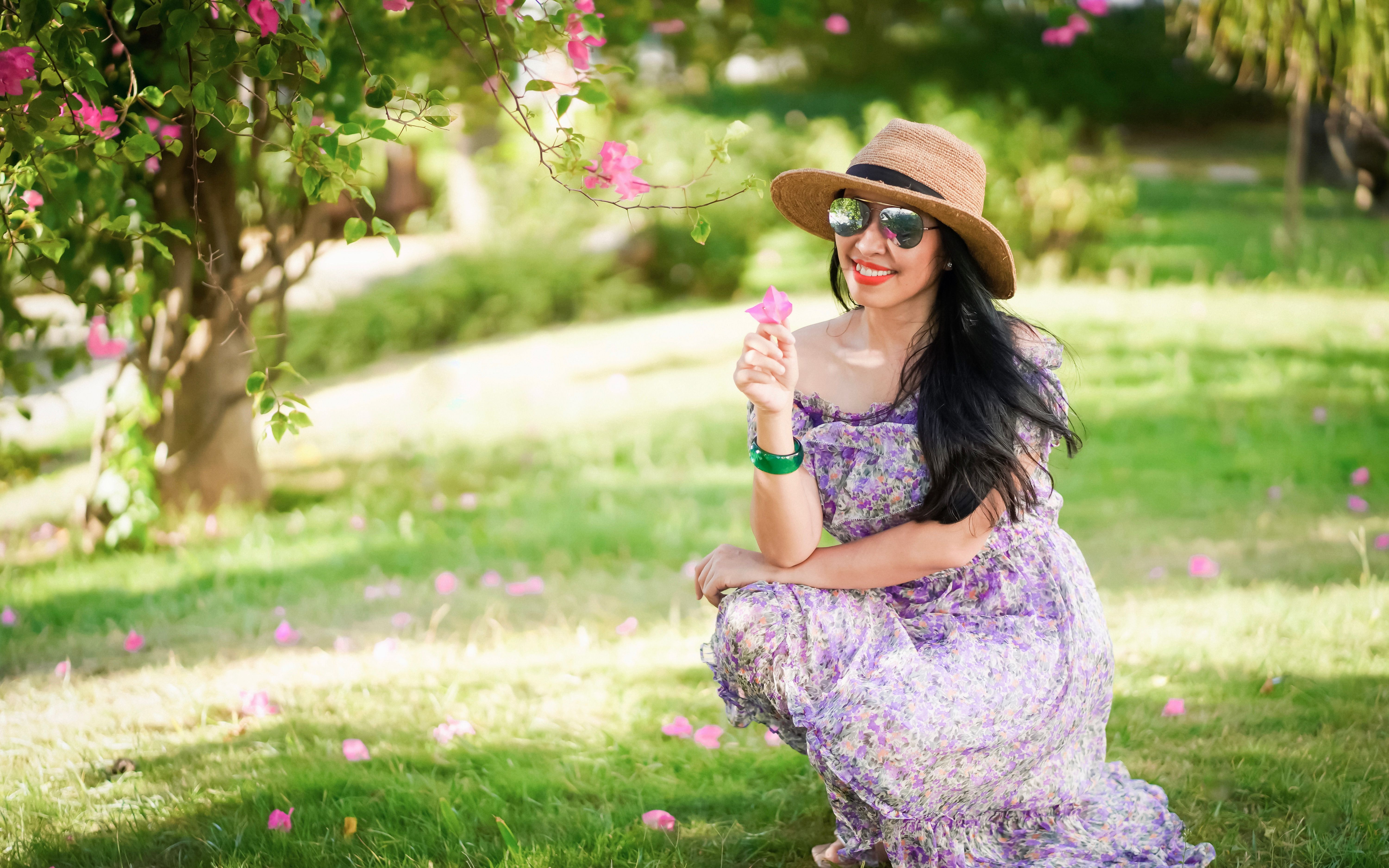 A Woman in Floral Print Dress Holding a Flower · Free Stock Photo