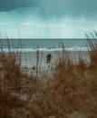 Man beachcombing with metal detector