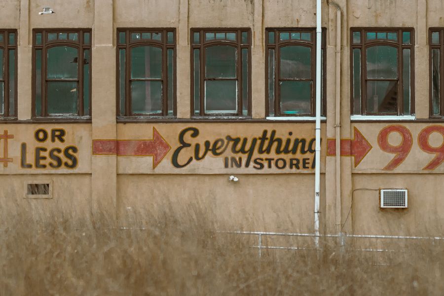 Vintage abandoned building with classic 99 cents store signage.