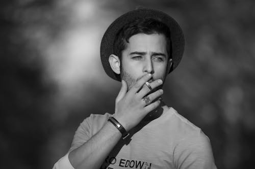 Monochrome Photo of Man smoking Cigarette 