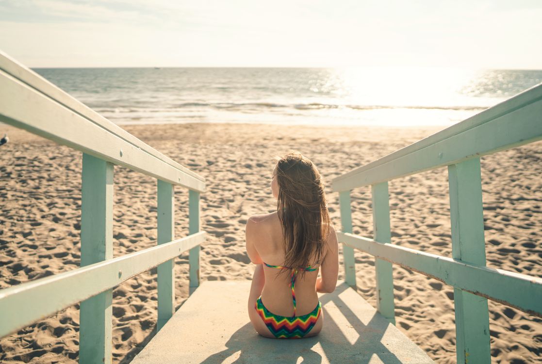 Woman in Bikini Sitting on a Beach · Free Stock Photo