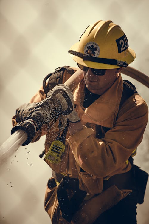 Selective Focus Of Firefighter With Water Hose Free Stock Photo