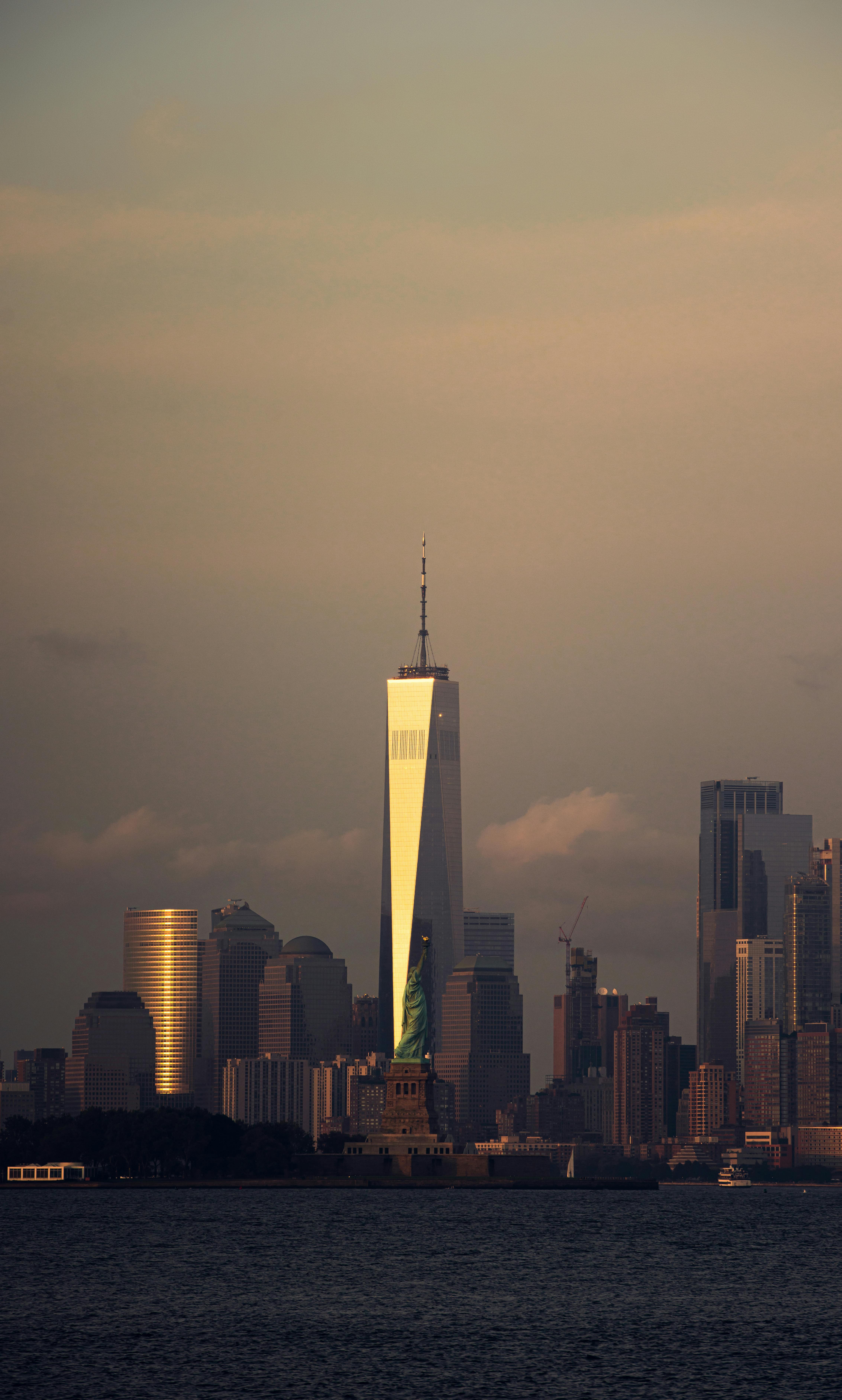 Scenic view of New York City's skyline with One World Trade Center at sunset.