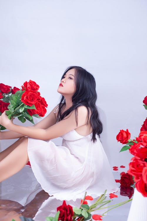 Pretty Girl in White Dress Holding Red Rose Flowers