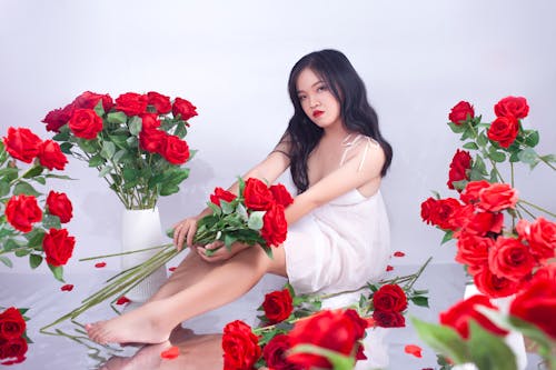Pretty Girl in White Dress Holding Red Rose Flowers