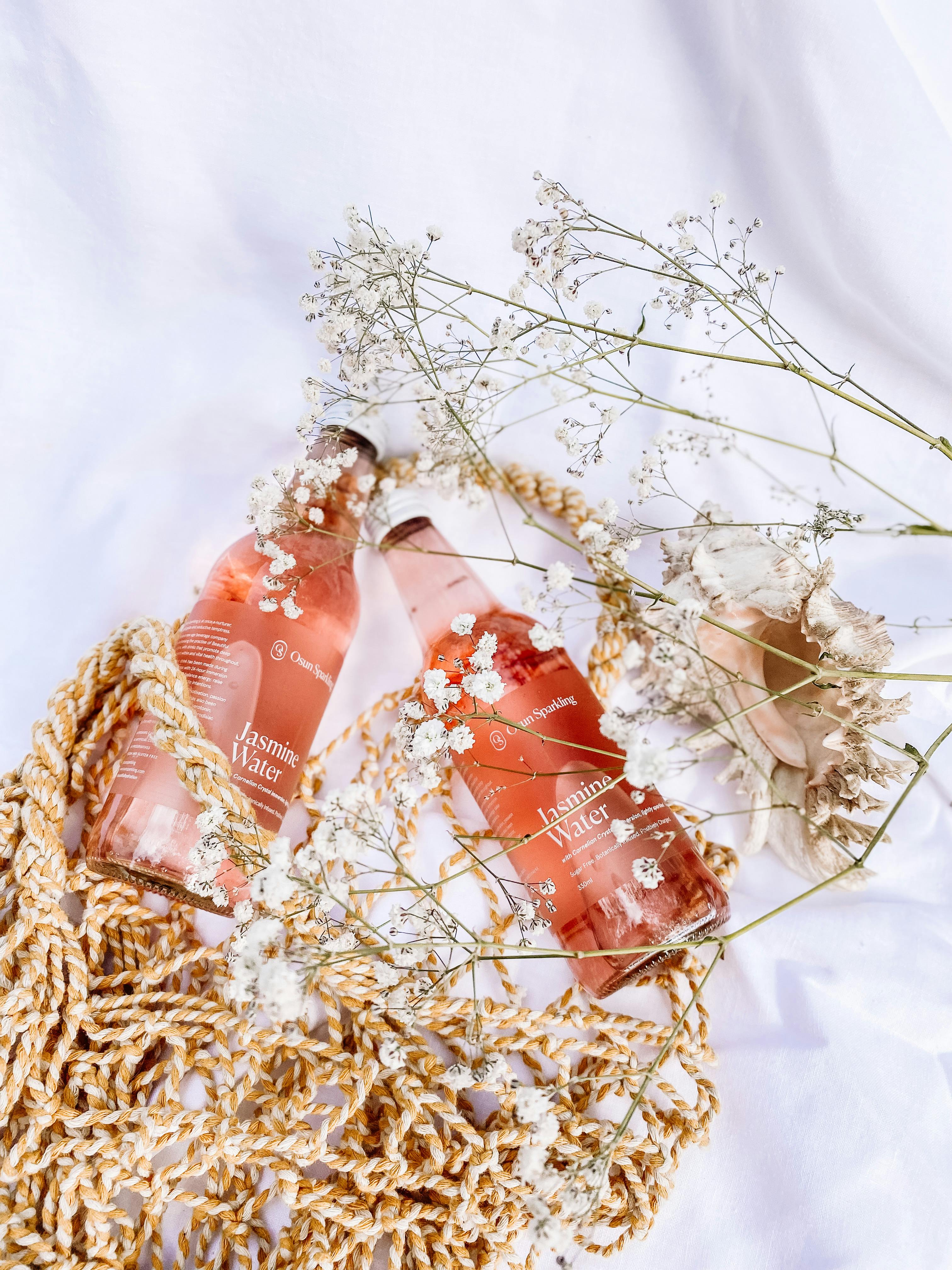 glass bottle and eco bag on white textile