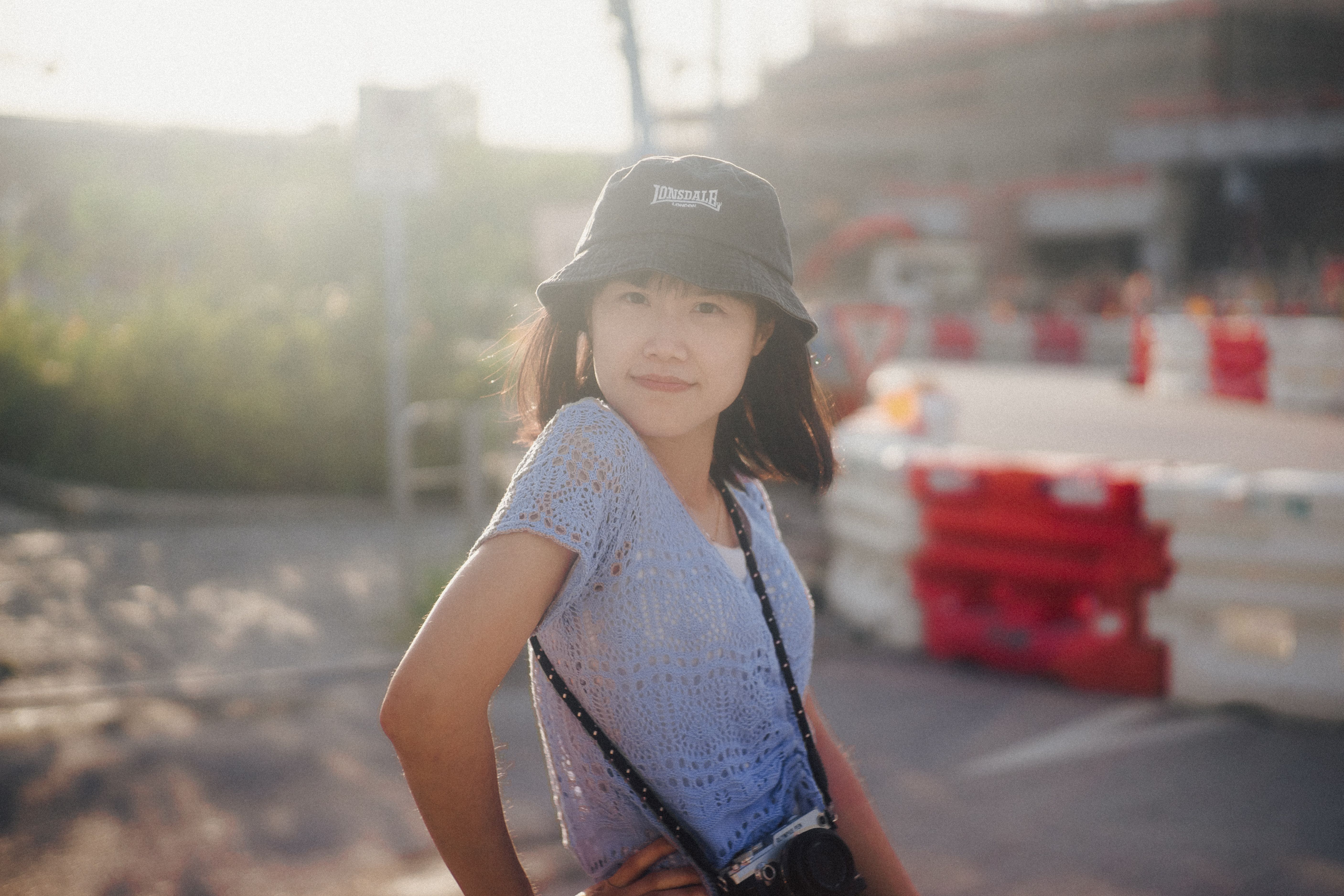 A Woman Posing with a Camera Strap Around Her Neck · Free Stock Photo