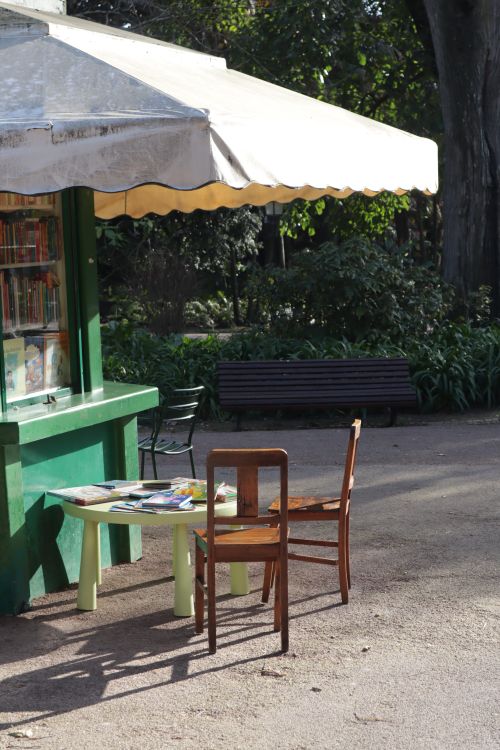 Free A peaceful outdoor park kiosk setting with chairs and a table in natural sunlight. Stock Photo