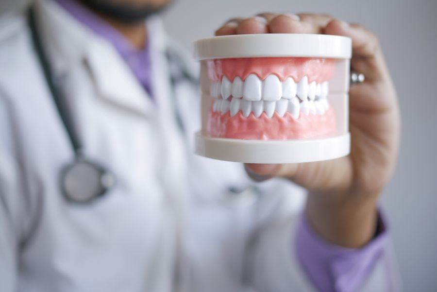 Dental professional handling a dental prosthetic in a clinic