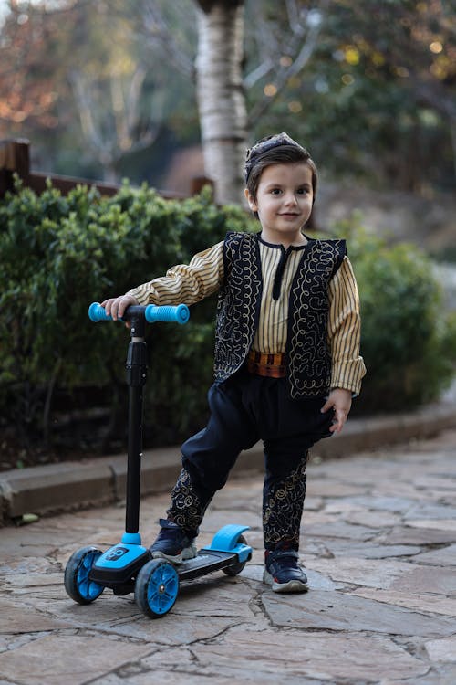 Free A Boy with a Trolley Wearing a Costume Stock Photo