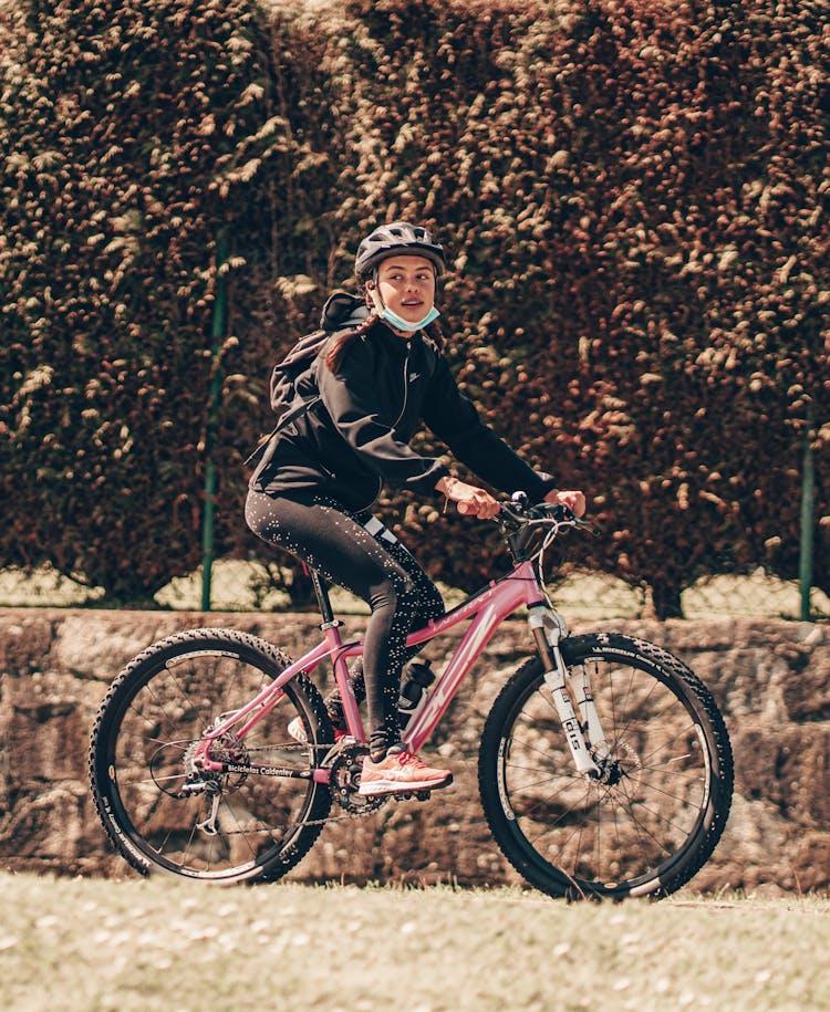 Young Woman Riding A Bicycle 