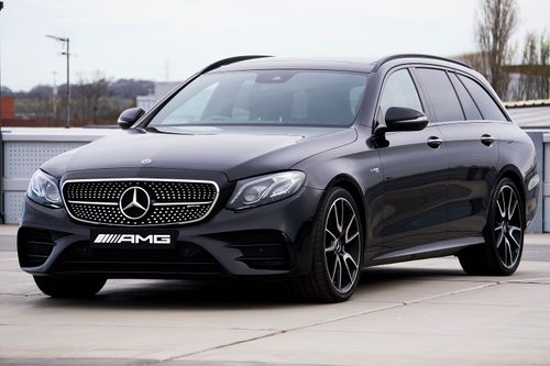 Free A luxurious black Mercedes-Benz AMG parked outdoors, showcasing its sleek design and elegance. Stock Photo