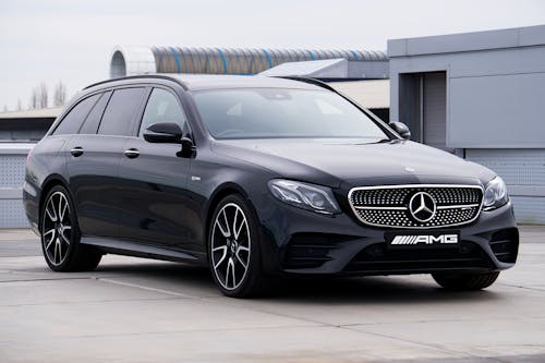 Free A Black Mercedes Benz Parked Beside Gray Building Stock Photo
