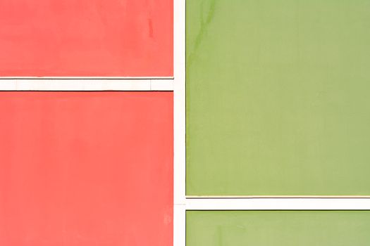 Colorful facade with red and green panels creating a minimalist architectural design.