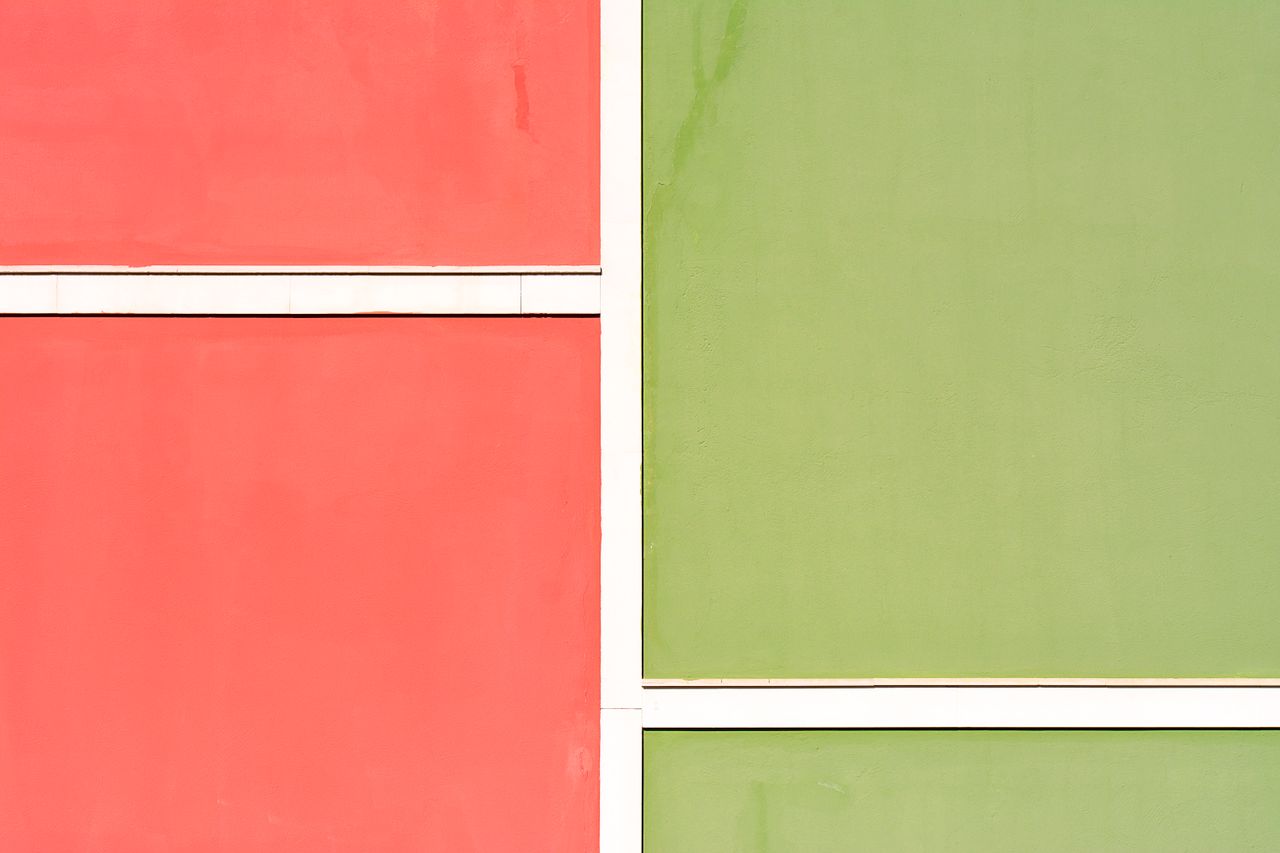 colorful facade with red and green panels creating a minimalist archit